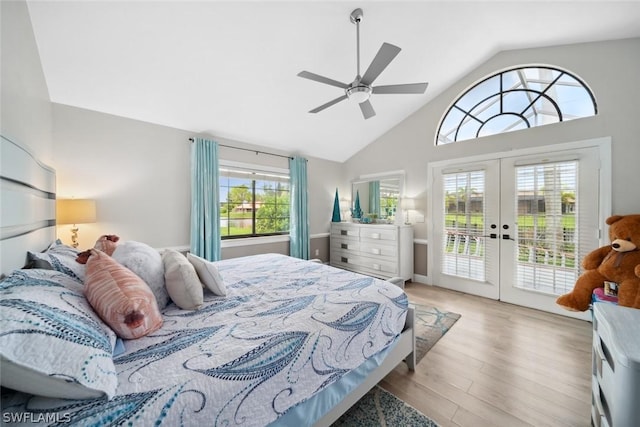 bedroom with ceiling fan, high vaulted ceiling, access to outside, french doors, and light wood-type flooring