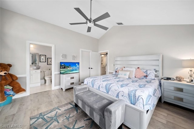 bedroom featuring vaulted ceiling, connected bathroom, ceiling fan, and light hardwood / wood-style flooring