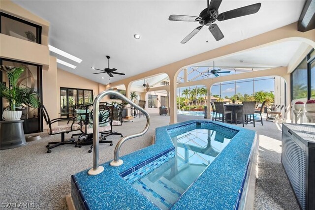 view of swimming pool featuring a skylight and ceiling fan