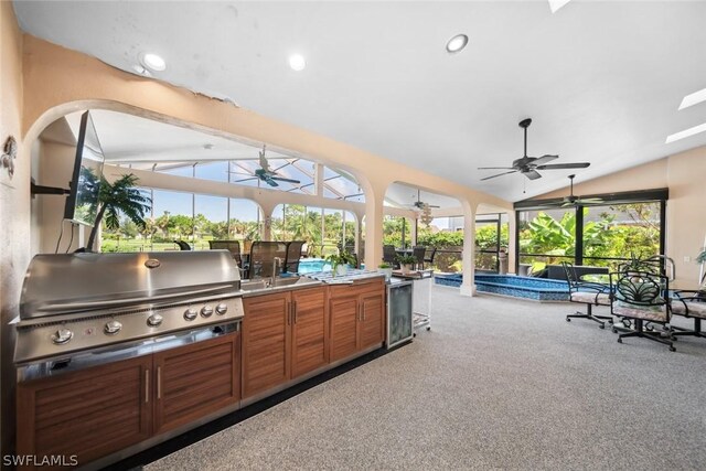 view of patio with grilling area, a swimming pool, ceiling fan, and area for grilling