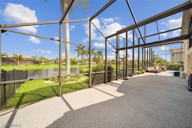 unfurnished sunroom with a water view