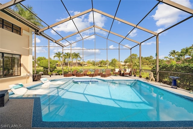 view of swimming pool with a patio area and a lanai