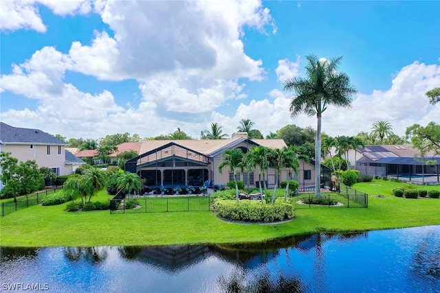 rear view of property with a yard and a water view