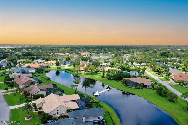 aerial view at dusk with a water view