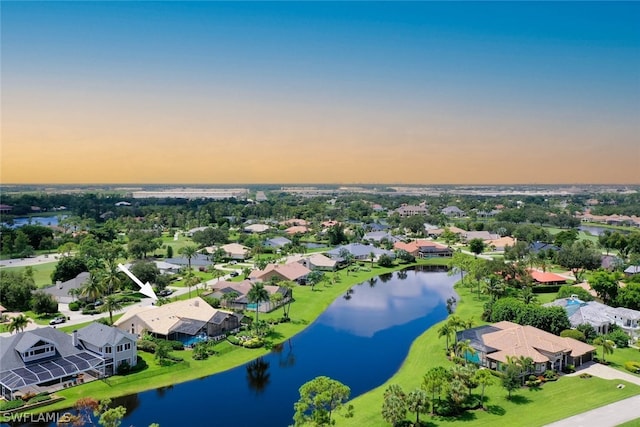 aerial view at dusk with a water view