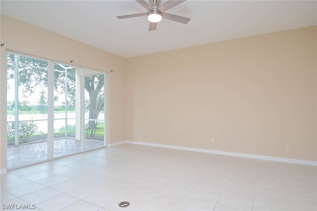 tiled spare room with ceiling fan