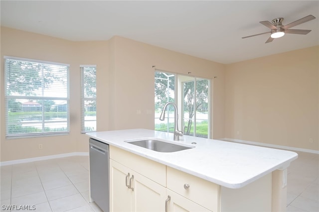 kitchen featuring light tile patterned flooring, stainless steel dishwasher, sink, and a center island with sink