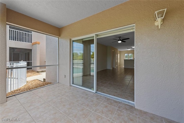 exterior space featuring a balcony and a ceiling fan