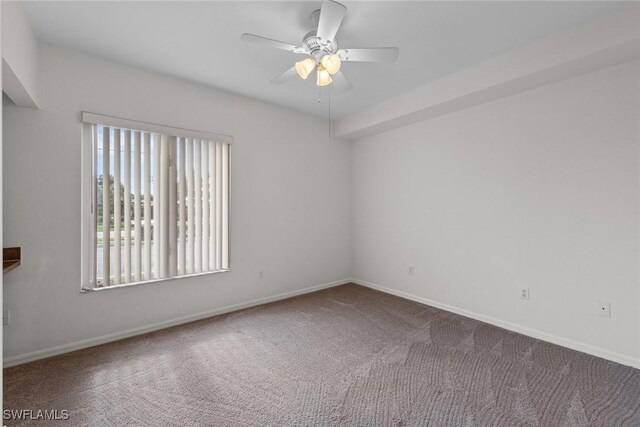 carpeted empty room featuring ceiling fan