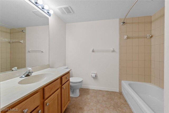 full bathroom with tiled shower / bath, tile patterned floors, toilet, and vanity