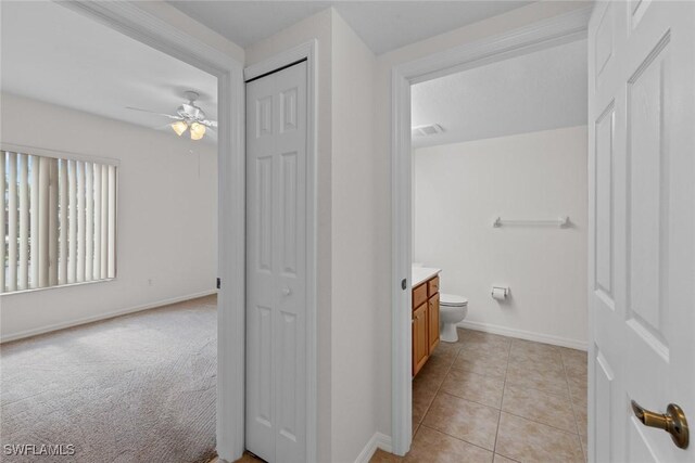 bathroom with ceiling fan, tile patterned floors, vanity, and toilet