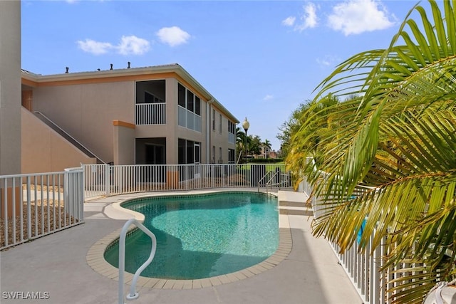 view of pool with a fenced in pool, fence, and a patio