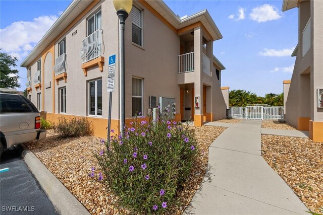 view of side of property with a balcony