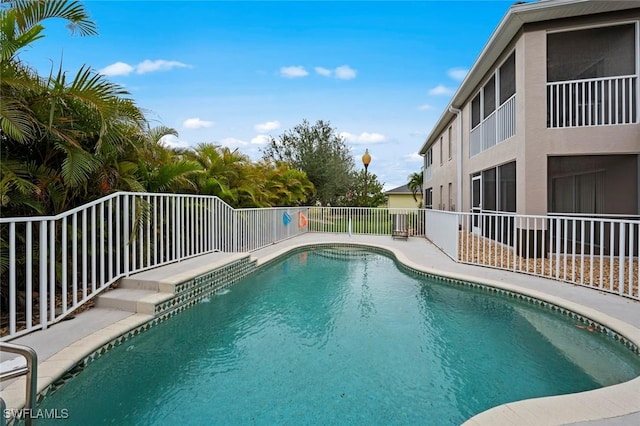 view of swimming pool featuring fence and a fenced in pool