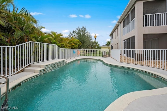 view of swimming pool featuring a fenced in pool and fence