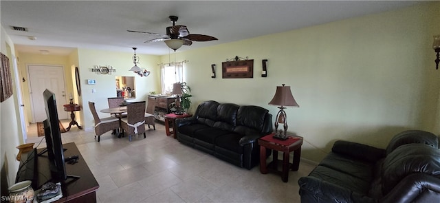 living room featuring light tile patterned floors and ceiling fan