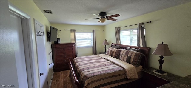 bedroom featuring wood-type flooring, a textured ceiling, and ceiling fan