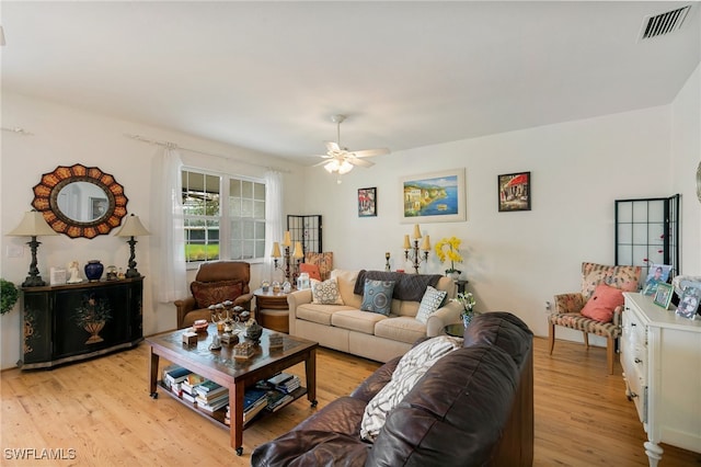 living room with light hardwood / wood-style floors and ceiling fan