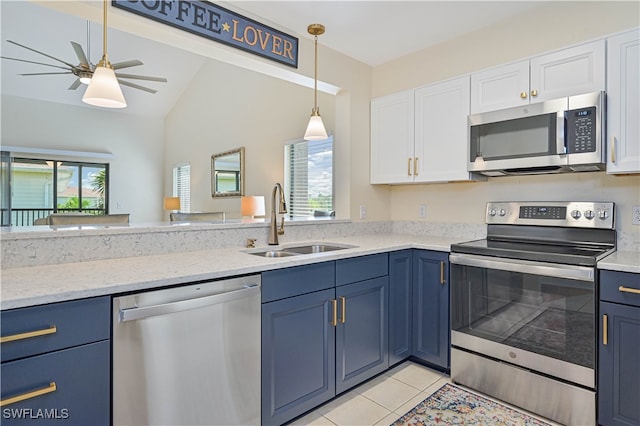 kitchen featuring ceiling fan, vaulted ceiling, sink, light tile patterned flooring, and stainless steel appliances