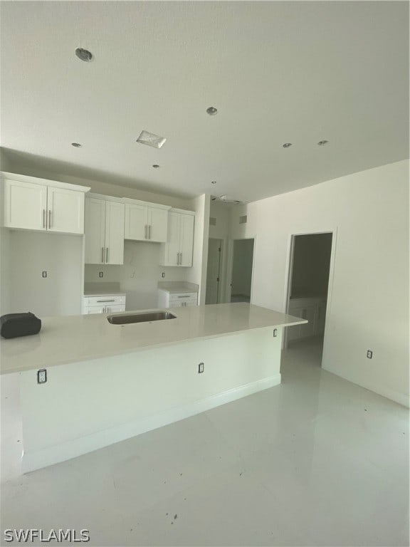 kitchen with white cabinets and a large island