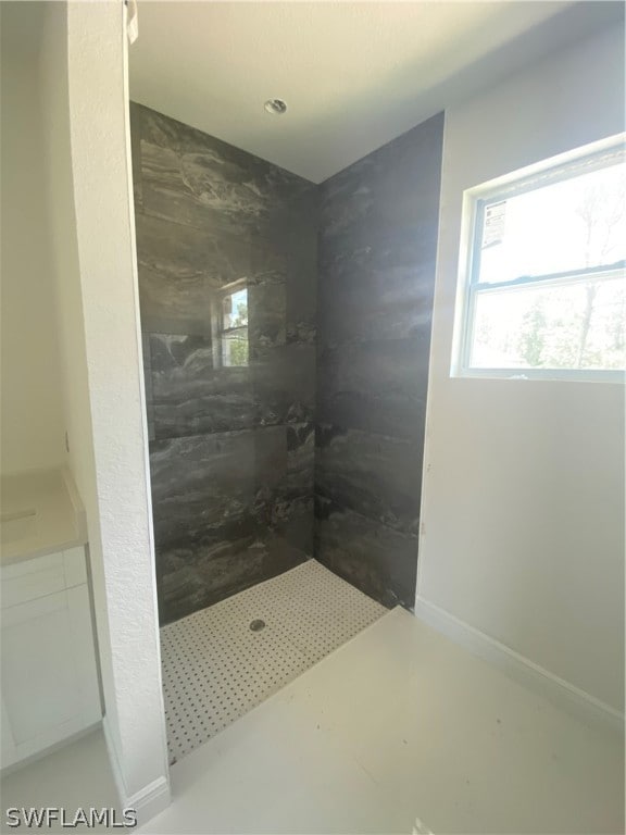 bathroom featuring vanity and a tile shower