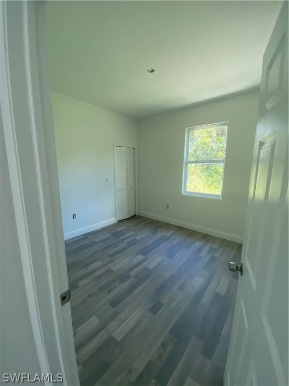 spare room with dark hardwood / wood-style floors