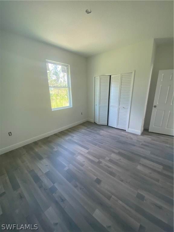 unfurnished bedroom with dark hardwood / wood-style floors