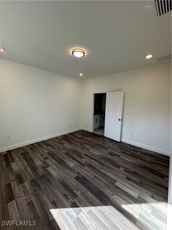 unfurnished room featuring dark hardwood / wood-style floors