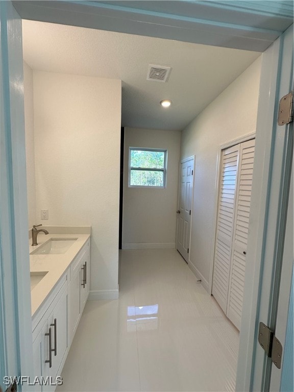 bathroom with tile patterned flooring and vanity