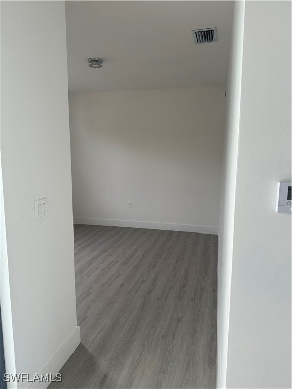 unfurnished room featuring dark wood-type flooring