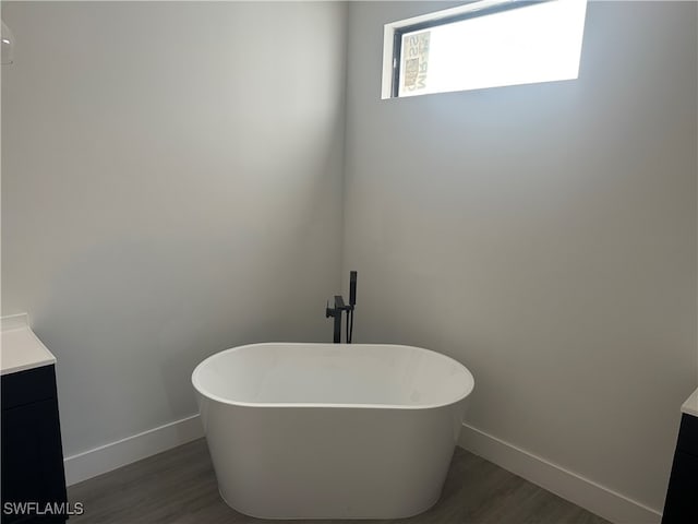 bathroom featuring a bathtub, hardwood / wood-style floors, and vanity