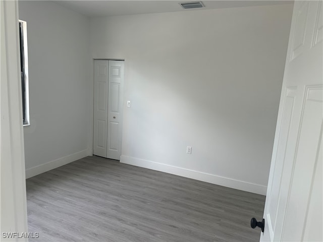 empty room with light hardwood / wood-style flooring