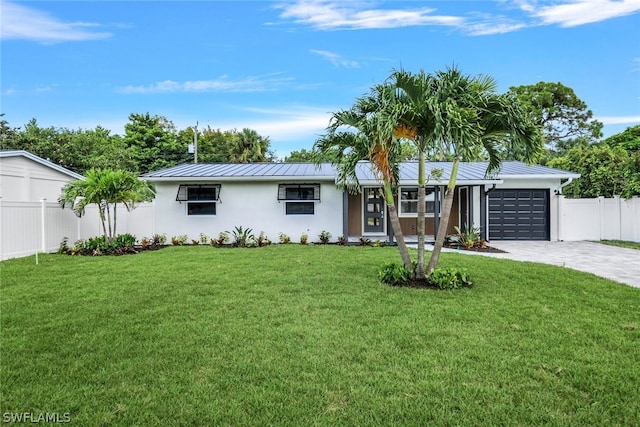 ranch-style home featuring a garage and a front yard