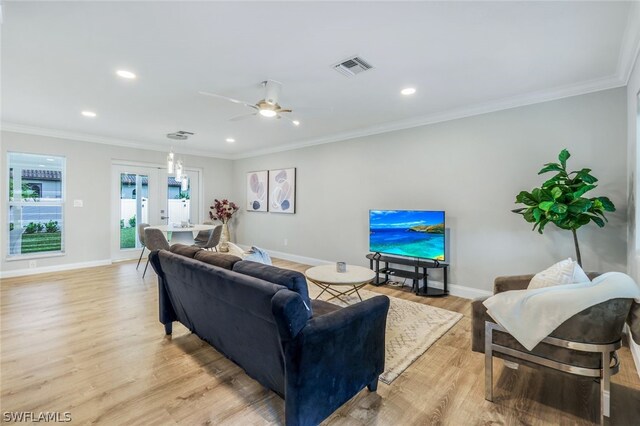 living room with ceiling fan, light hardwood / wood-style flooring, and ornamental molding