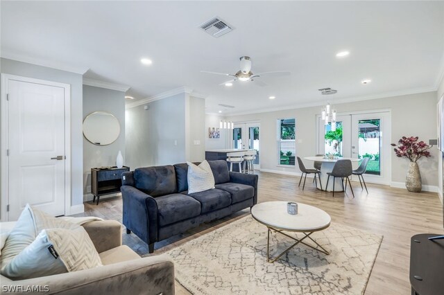 living room featuring ceiling fan, french doors, light wood-type flooring, and crown molding