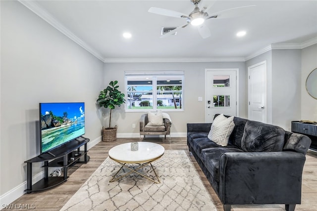 living room featuring ceiling fan, light hardwood / wood-style flooring, and ornamental molding