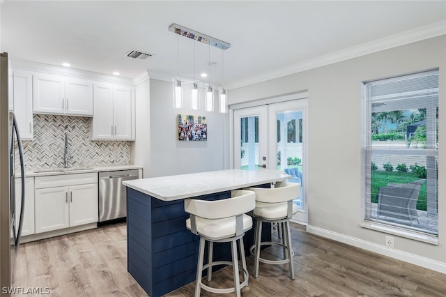 kitchen featuring light hardwood / wood-style floors, sink, dishwasher, and white cabinets