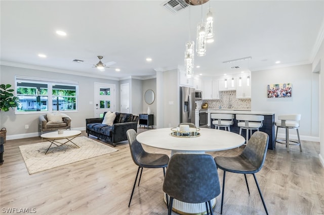 dining room featuring ceiling fan, light hardwood / wood-style flooring, and ornamental molding