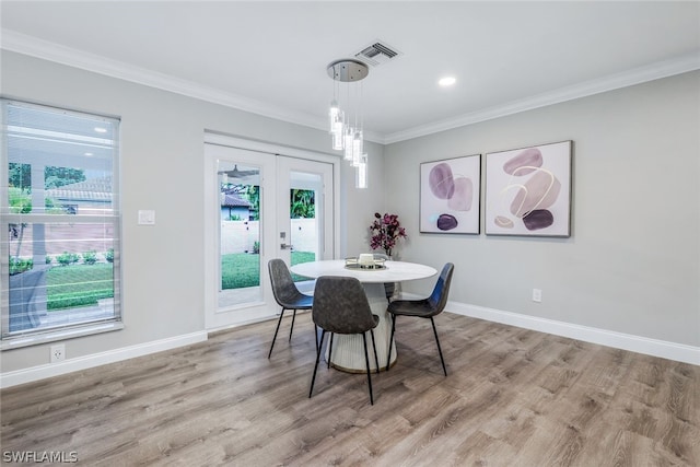 dining area with crown molding, french doors, and hardwood / wood-style flooring