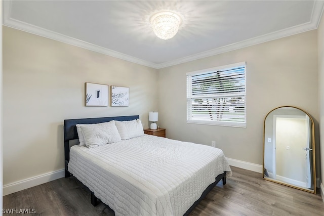 bedroom featuring wood-type flooring and crown molding