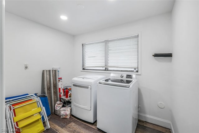 washroom featuring washing machine and clothes dryer and dark wood-type flooring