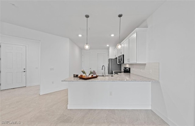 kitchen with sink, white cabinetry, hanging light fixtures, appliances with stainless steel finishes, and kitchen peninsula