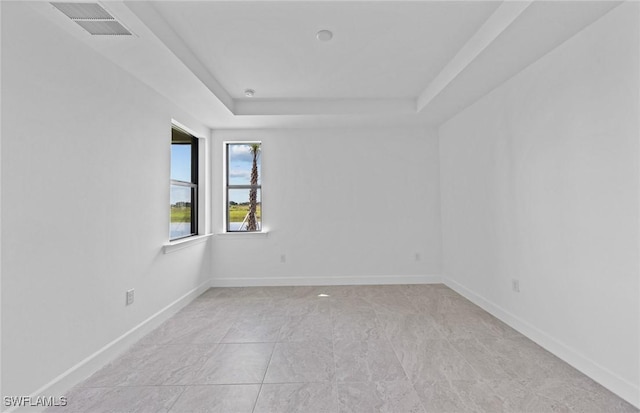 empty room with a raised ceiling