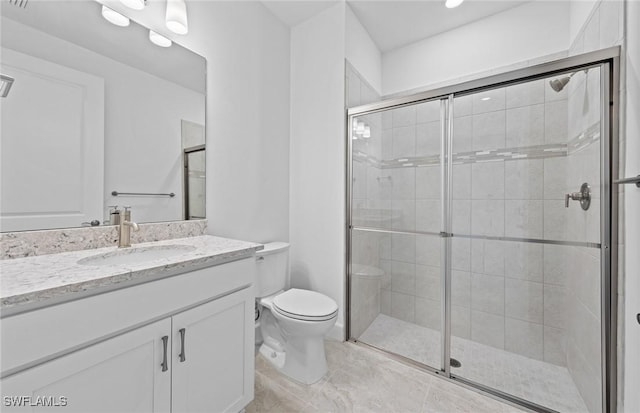 bathroom with vanity, toilet, and an enclosed shower