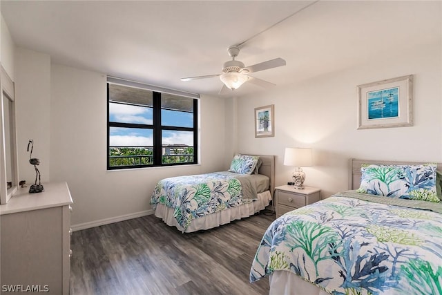 bedroom featuring a ceiling fan, baseboards, and dark wood-style flooring