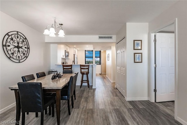 dining area featuring visible vents, baseboards, and dark wood-type flooring