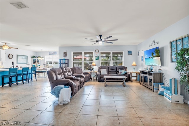 tiled living room featuring ceiling fan