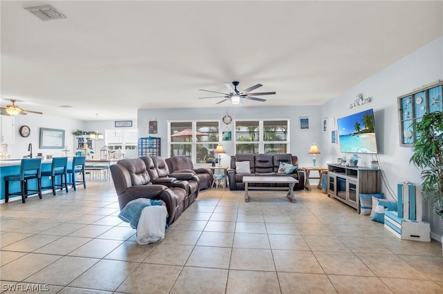 tiled living room with ceiling fan and a healthy amount of sunlight