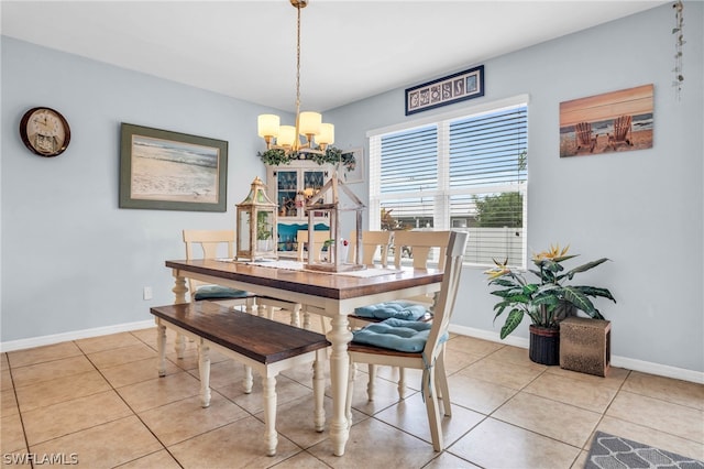 dining room featuring light tile patterned flooring and a chandelier