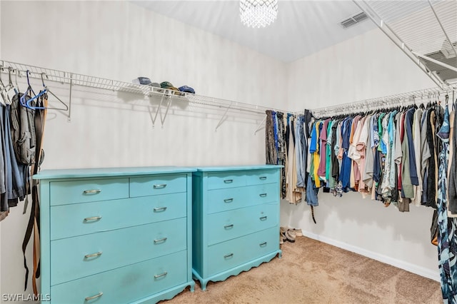 walk in closet featuring light colored carpet